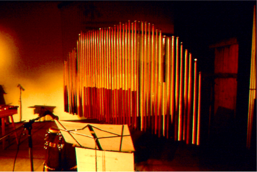 Cubular bells: cue sticks hung in a row from a long 2x4