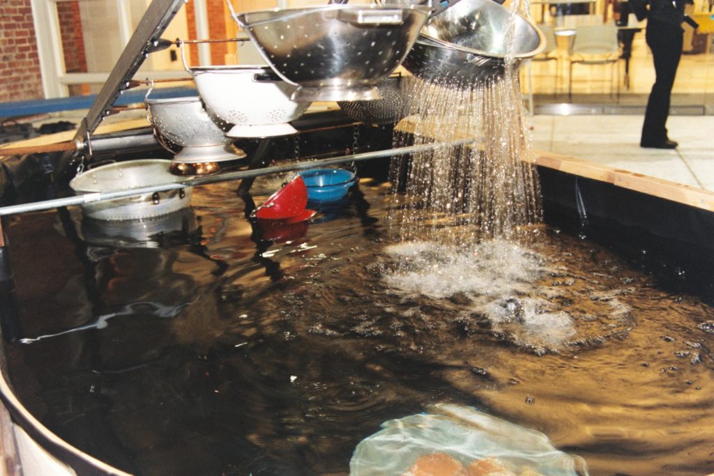 water pours from a large colander