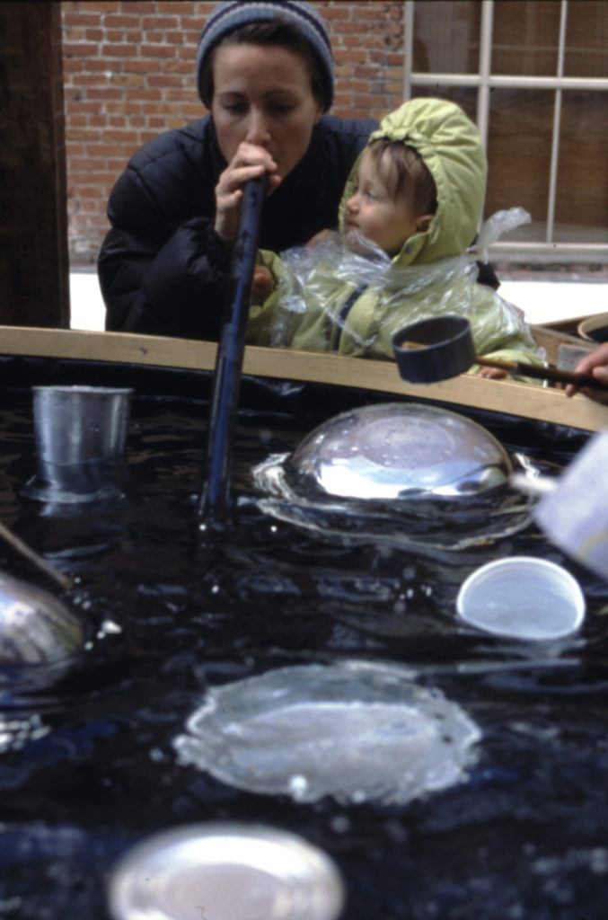 visitors play with tubes and floating bowls