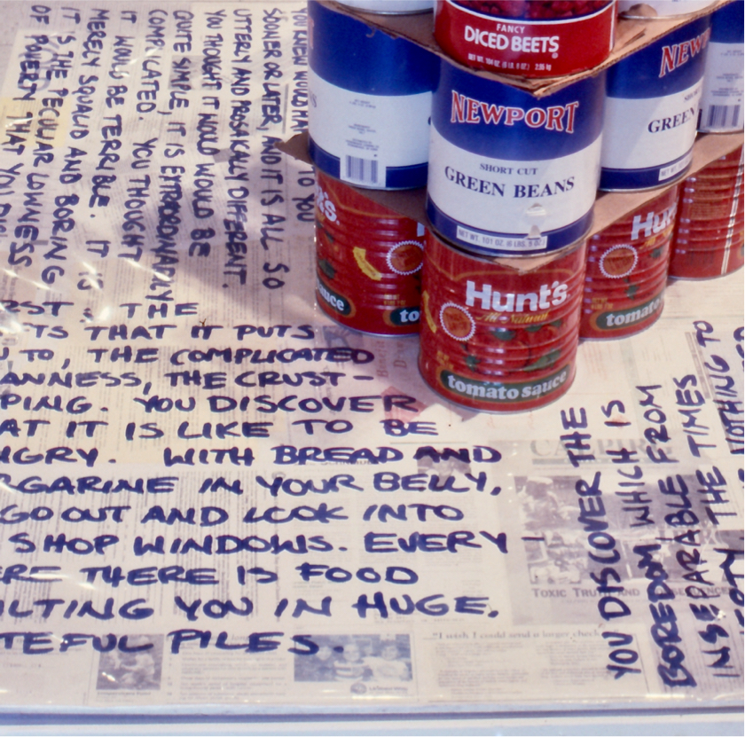 Detail: stacked cans on base with quotes.